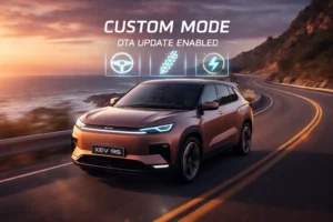 Mahindra XEV 9S electric SUV driving on a coastal highway at sunset with Custom Mode and OTA update digital HUD icons showing steering suspension and performance controls