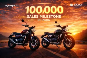 Triumph Speed 400 and Scrambler 400X motorcycles parked on an Indian highway celebrating 100000 sales milestone in India under the Triumph and Bajaj partnership.
